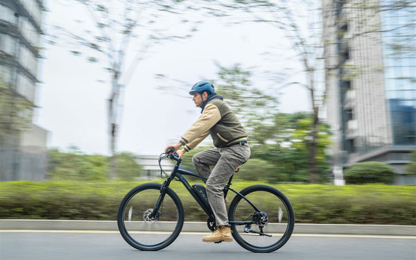 TXED Trail electric bike rider on an urban road