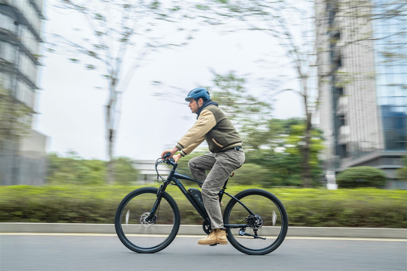 TXED Trail electric bike rider on an urban road