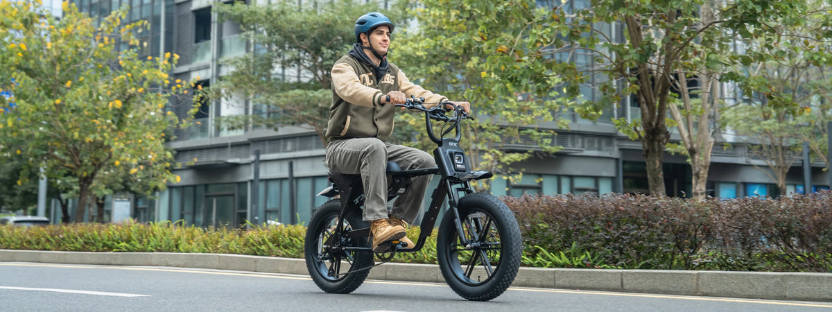 A helmeted rider on a TXED Maverick electric bike on a city street.